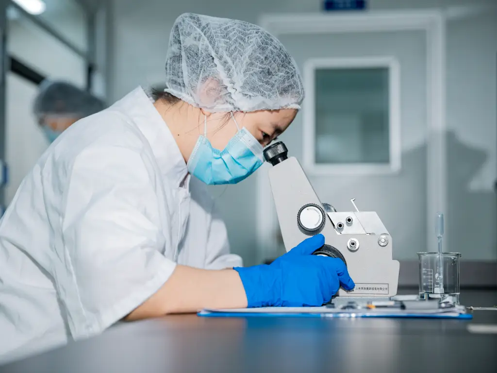 Kimdee's lab worker is analyzing the finished product report at the table, with a sample of the noodle on the side