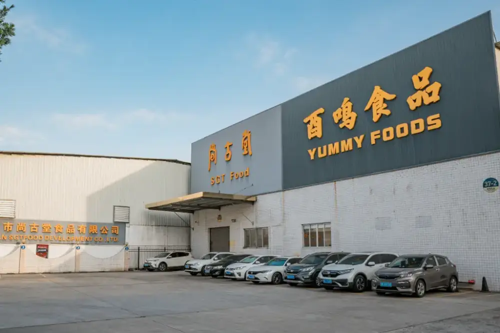 The front of the Kimdee organic noodles and prepared food factory, with the names of the two factories clearly displayed