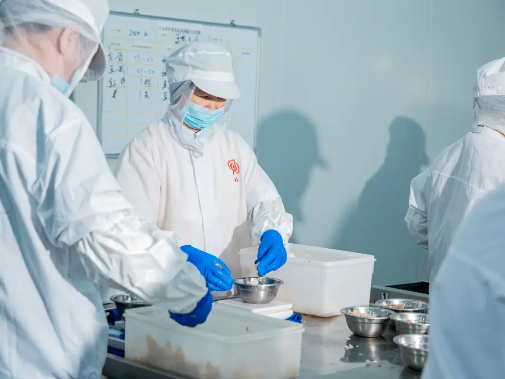 Workers inspect the production line while processing raw materials